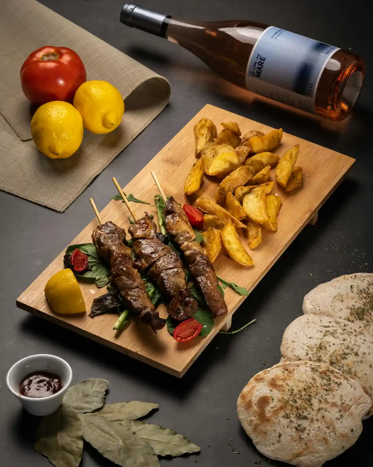 Tasty platter with grilled skewers and crispy oven-baked steak fries