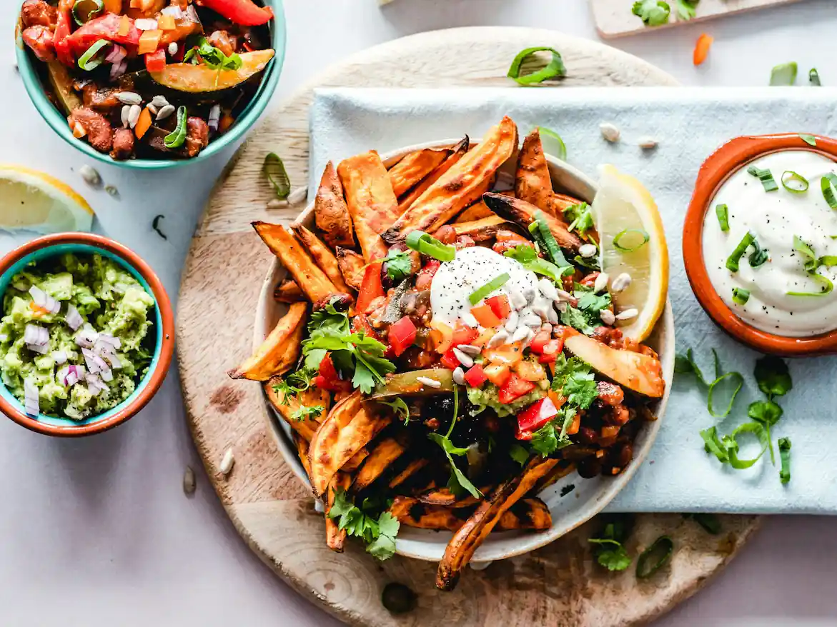 A mixed bowl of crispy oven-baked steak fries and vegetables
